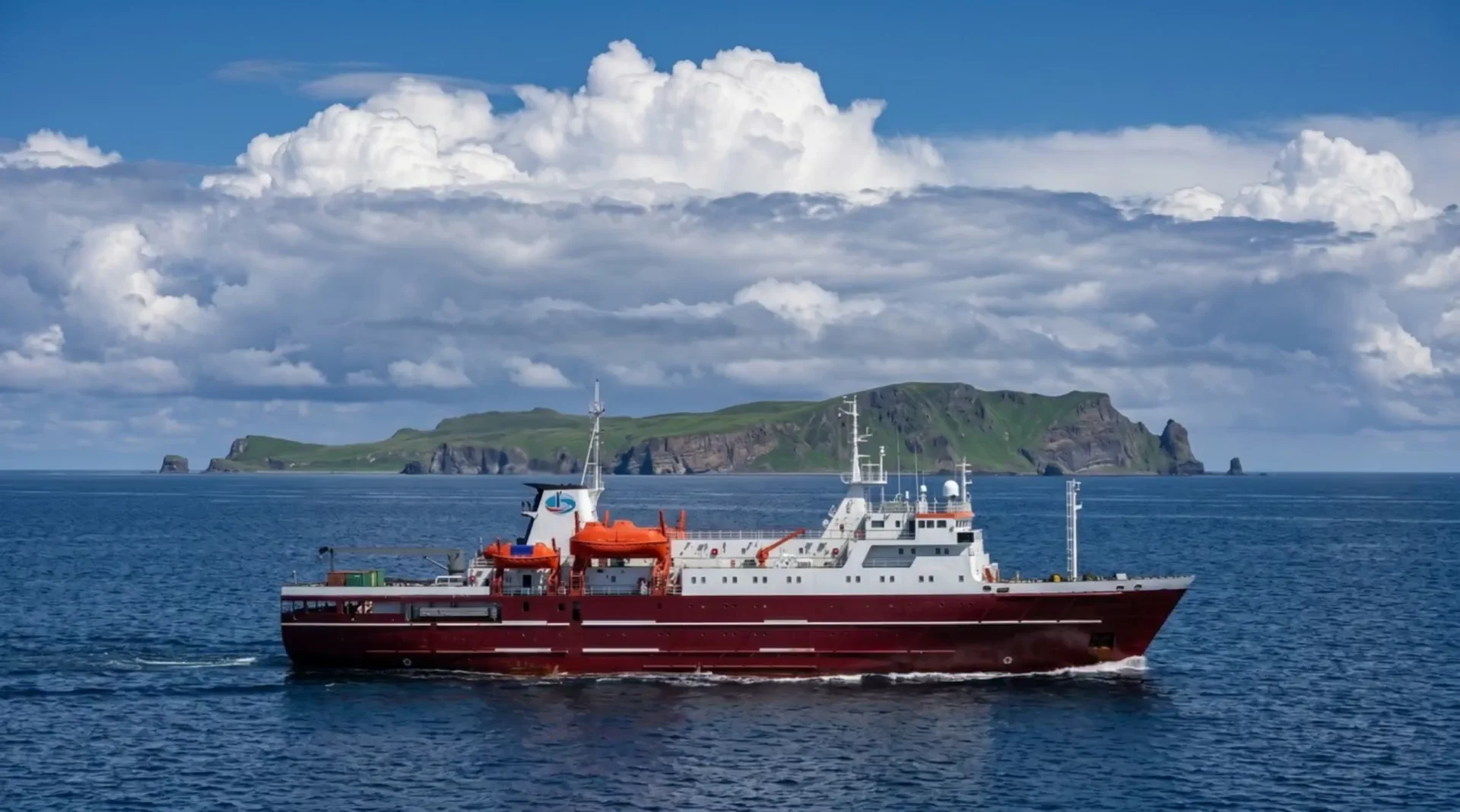 M/V Igor Farkhutdinov — the maroon-red passenger-cargo vessel at sea on the Korsakov — Moneron route