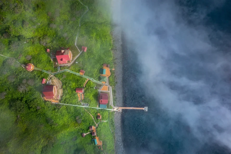 Moneron's guest station from above — lodges, jetty, and the reserve's launches