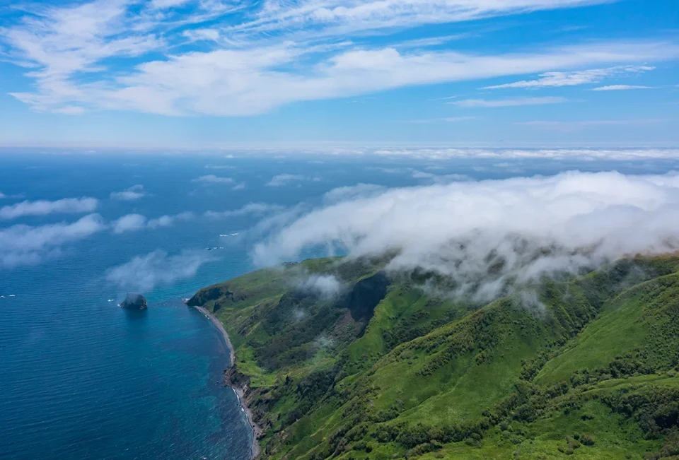 Moneron's shore from above wreathed in cloud — the Sakhalin region's marine nature park